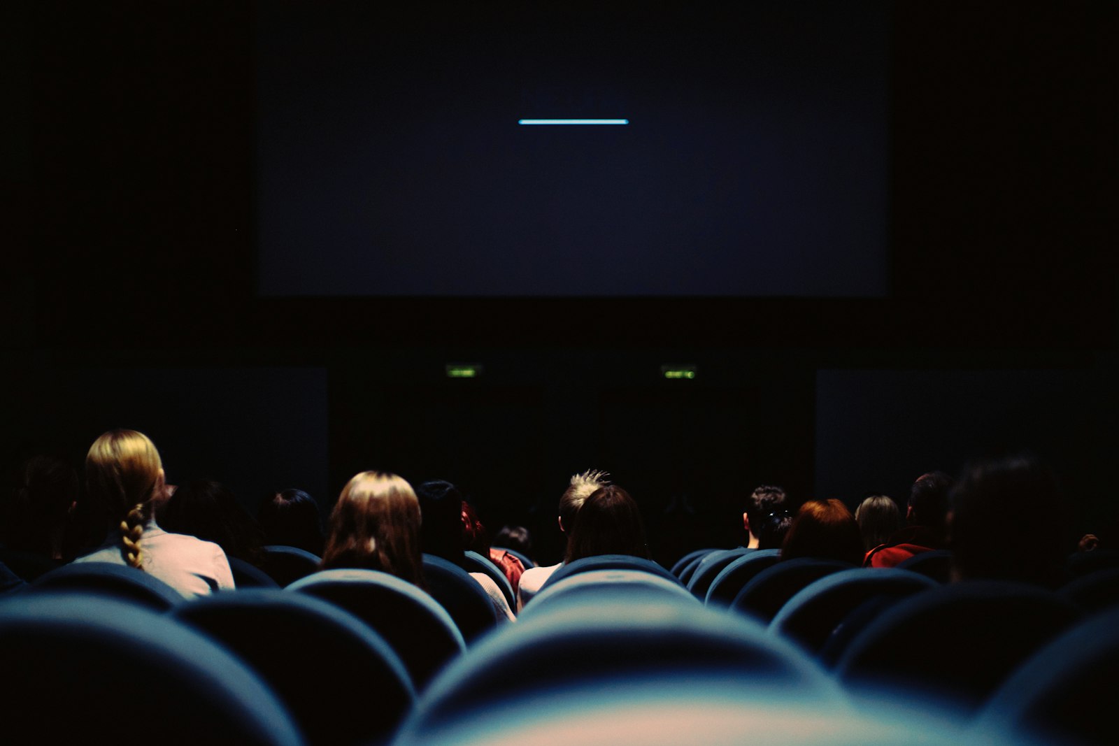 An audience settling in as the screen lights up