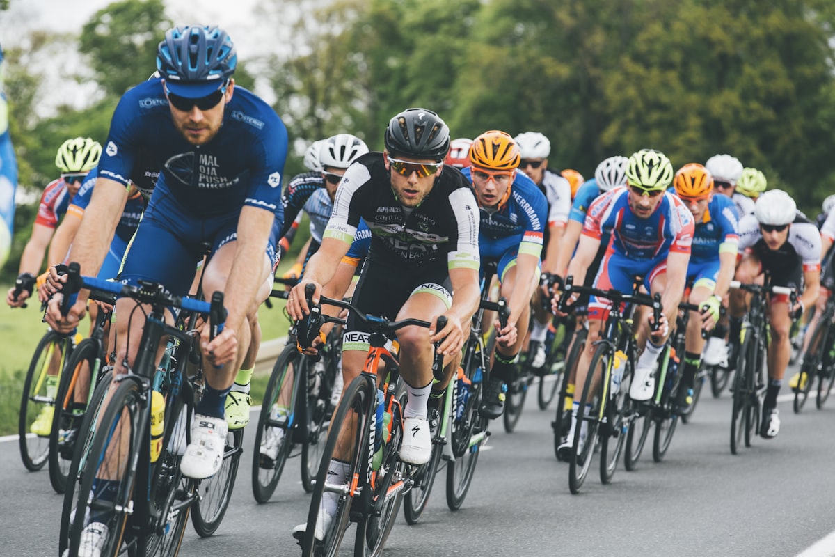 A cycling peloton charging down the road
